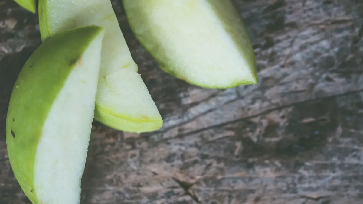 A gray-muzzled dog sniffing apple slices set on a kitchen floor