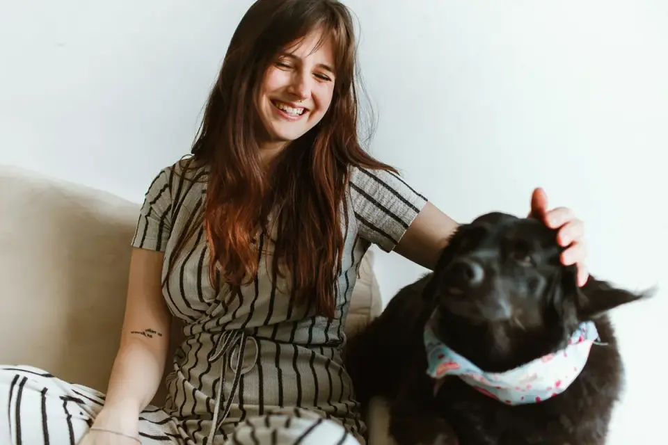A veterinarian gently examining an anxious small dog during a wellness visit