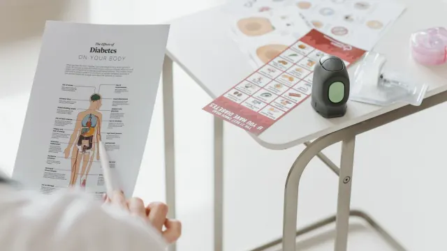 A veterinarian reviewing a dog supplement label next to a senior dog on an exam table