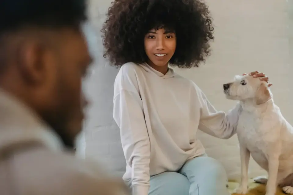 Dog in a kitchen with an owner